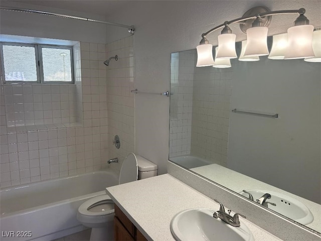 full bathroom with vanity, toilet, and tiled shower / bath