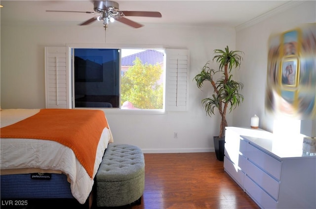 bedroom with ceiling fan, dark hardwood / wood-style flooring, and crown molding