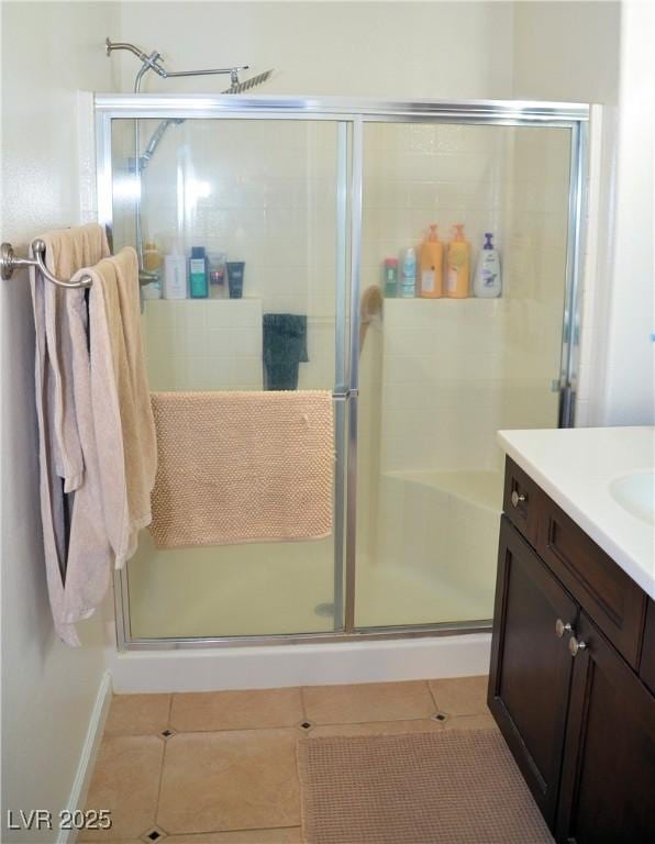 bathroom with vanity, tile patterned floors, and a shower with shower door