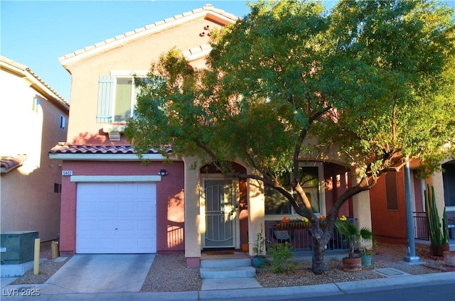 mediterranean / spanish house with a garage