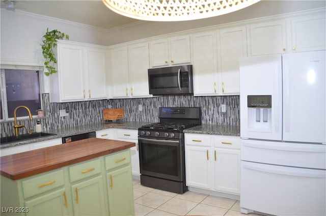 kitchen with white refrigerator with ice dispenser, sink, tasteful backsplash, white cabinetry, and black range with gas cooktop