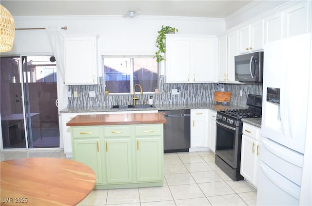 kitchen with black appliances, white cabinets, sink, and a wealth of natural light