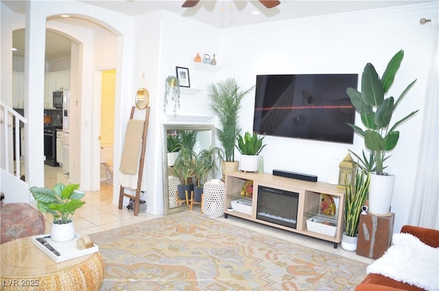 living room featuring crown molding and light tile patterned flooring