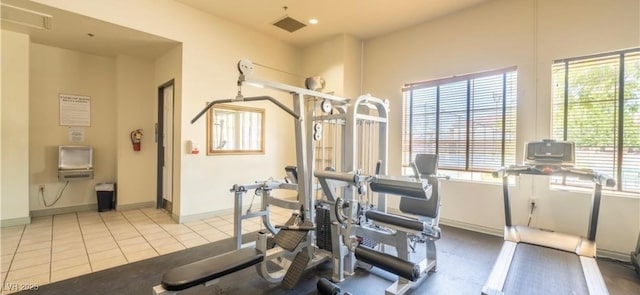 workout room featuring light tile patterned floors