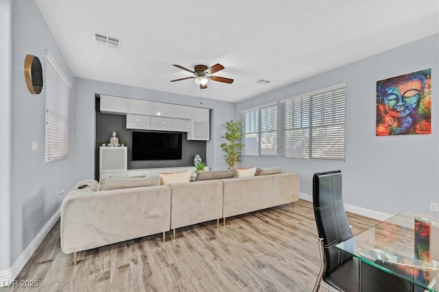 living room featuring light wood-type flooring and ceiling fan