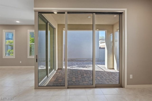 doorway featuring light tile patterned flooring