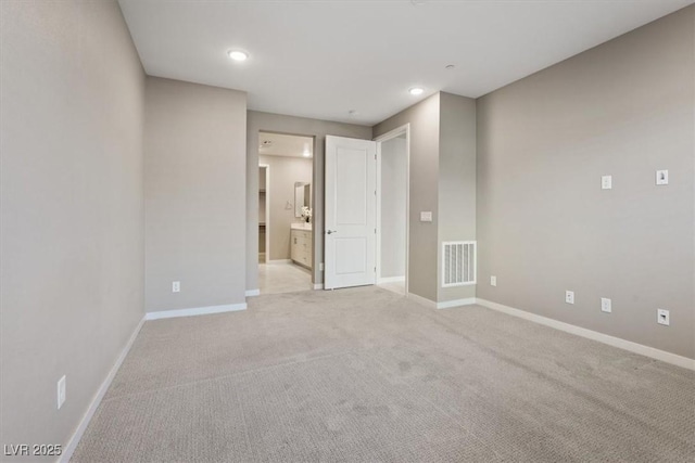 unfurnished room with light colored carpet