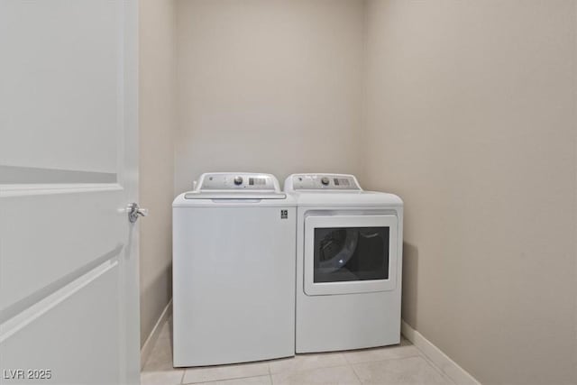 washroom featuring light tile patterned flooring and washing machine and clothes dryer