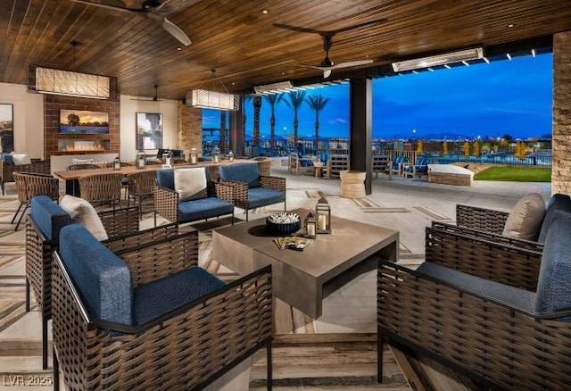 interior space with an outdoor living space and ceiling fan