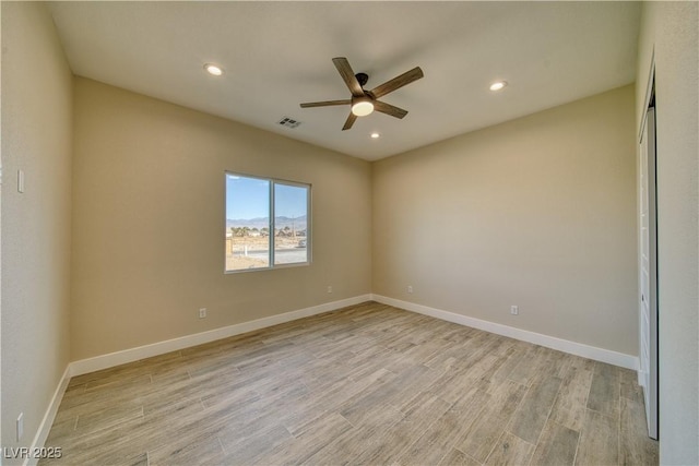 empty room with light hardwood / wood-style floors and ceiling fan