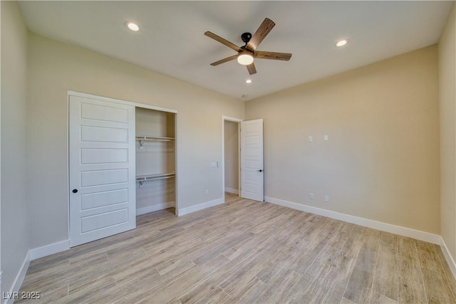 unfurnished bedroom with ceiling fan, light wood-type flooring, and a closet