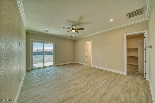 spare room with crown molding, a water view, ceiling fan, and light wood-type flooring