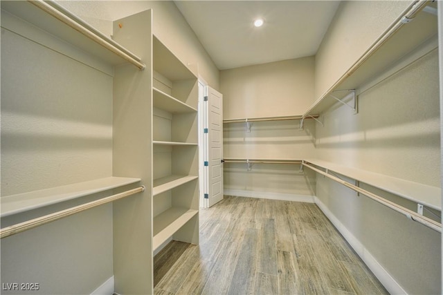 spacious closet with light hardwood / wood-style floors