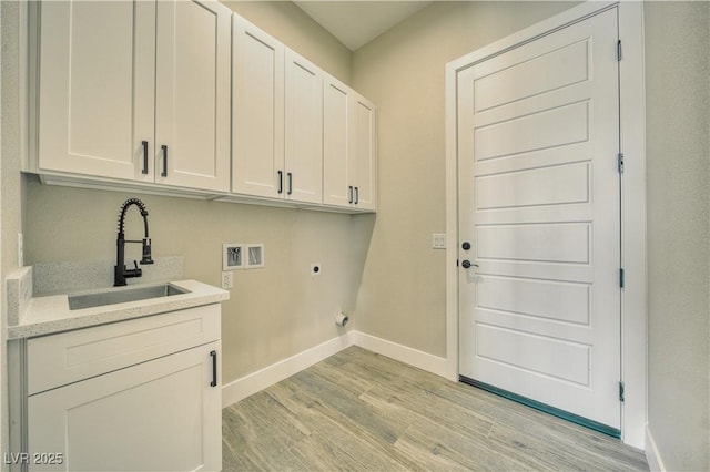 laundry room with sink, hookup for a washing machine, cabinets, light hardwood / wood-style floors, and hookup for an electric dryer