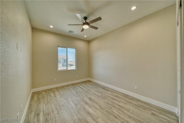 spare room featuring ceiling fan and light wood-type flooring