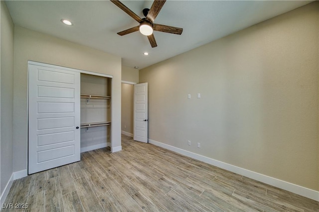 unfurnished bedroom featuring ceiling fan, light hardwood / wood-style floors, and a closet