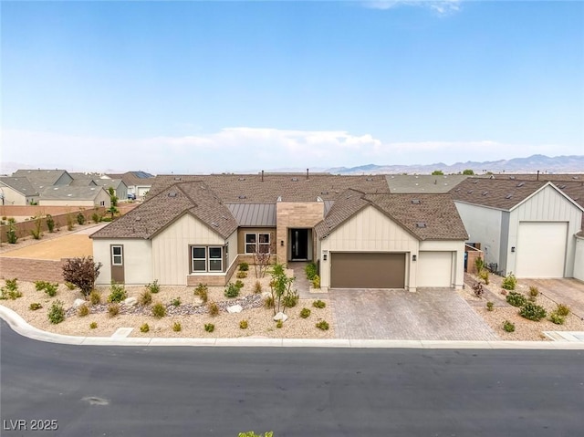 view of front of property featuring a mountain view and a garage