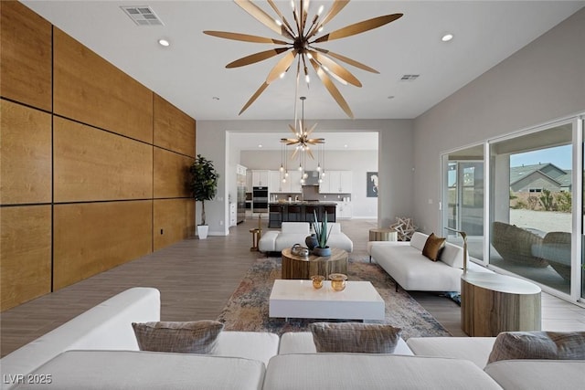 living room featuring dark hardwood / wood-style floors and a notable chandelier