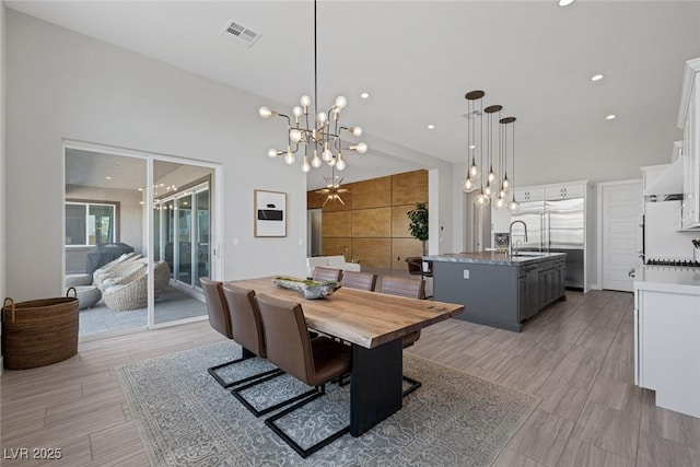 dining space with a notable chandelier and sink