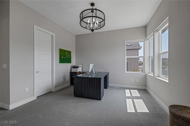 carpeted office space featuring a chandelier