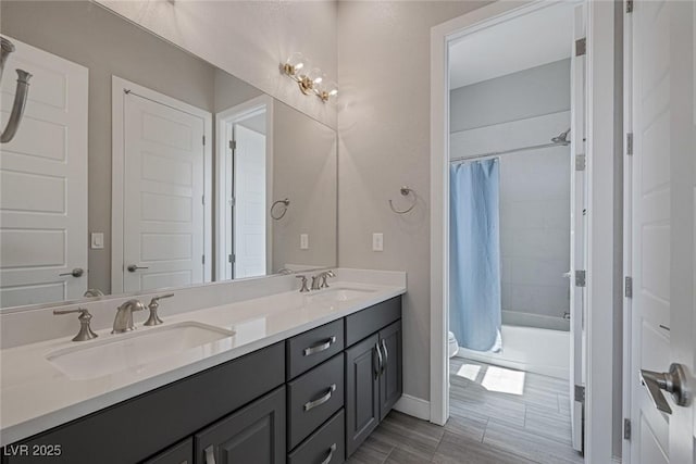 full bathroom featuring vanity, shower / bath combination with curtain, and toilet