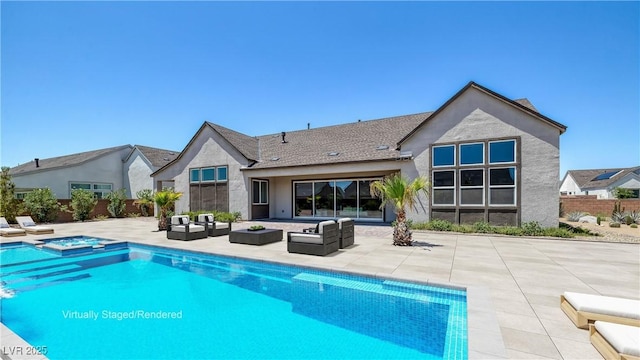 back of property featuring an in ground hot tub, an outdoor hangout area, and a patio