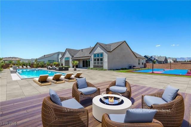 view of pool featuring cooling unit and a patio