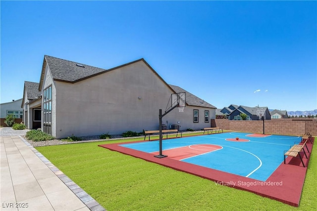 view of sport court with a yard