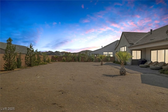 yard at dusk with a patio