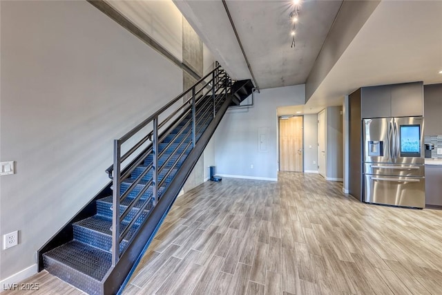 staircase with hardwood / wood-style floors