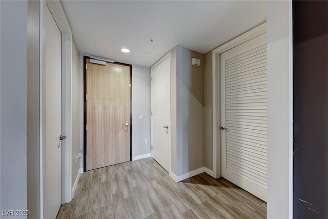 corridor with light wood-type flooring