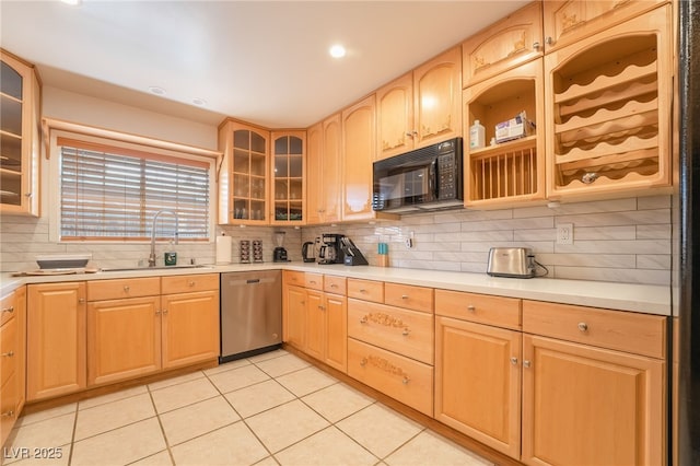 kitchen with light brown cabinets, sink, stainless steel dishwasher, decorative backsplash, and light tile patterned floors