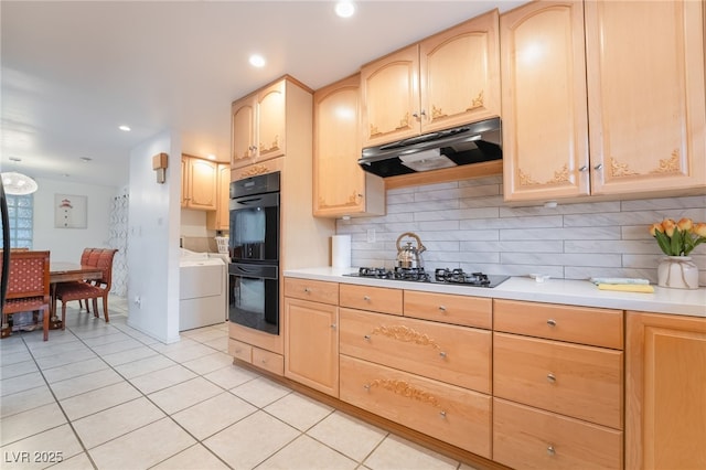 kitchen with light brown cabinetry, tasteful backsplash, light tile patterned floors, and black appliances