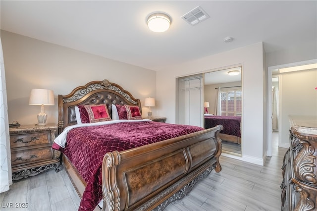 bedroom featuring light wood-type flooring and a closet