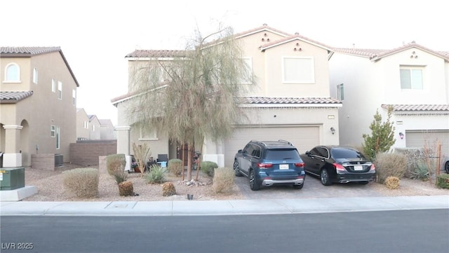 mediterranean / spanish-style house with a garage and central AC