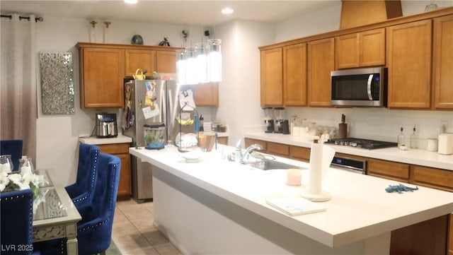 kitchen with light tile patterned flooring, sink, and appliances with stainless steel finishes