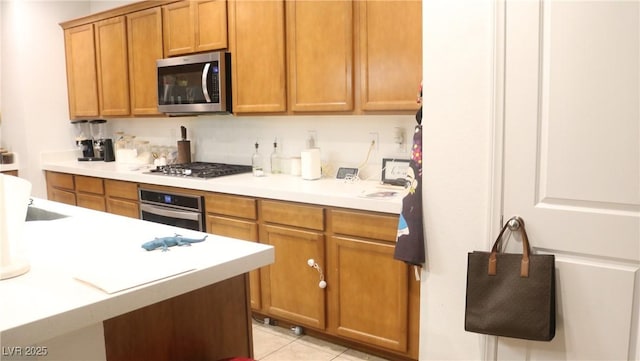 kitchen featuring light tile patterned floors and appliances with stainless steel finishes