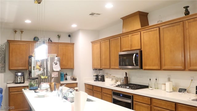 kitchen featuring decorative light fixtures and appliances with stainless steel finishes