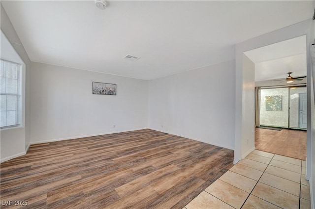 empty room featuring ceiling fan and light wood-type flooring