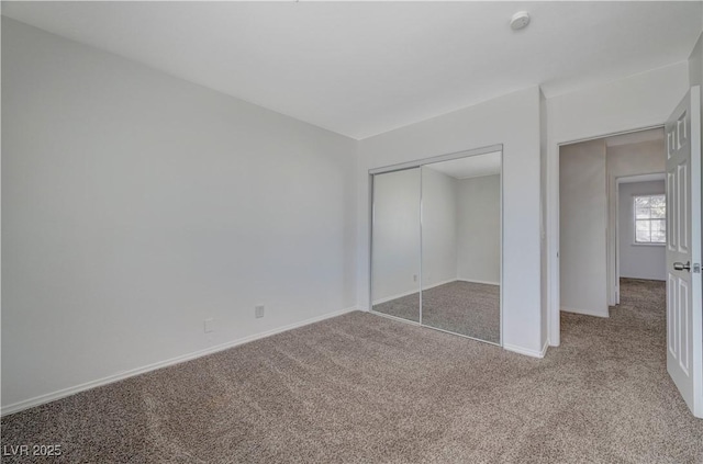 unfurnished bedroom featuring a closet and carpet floors