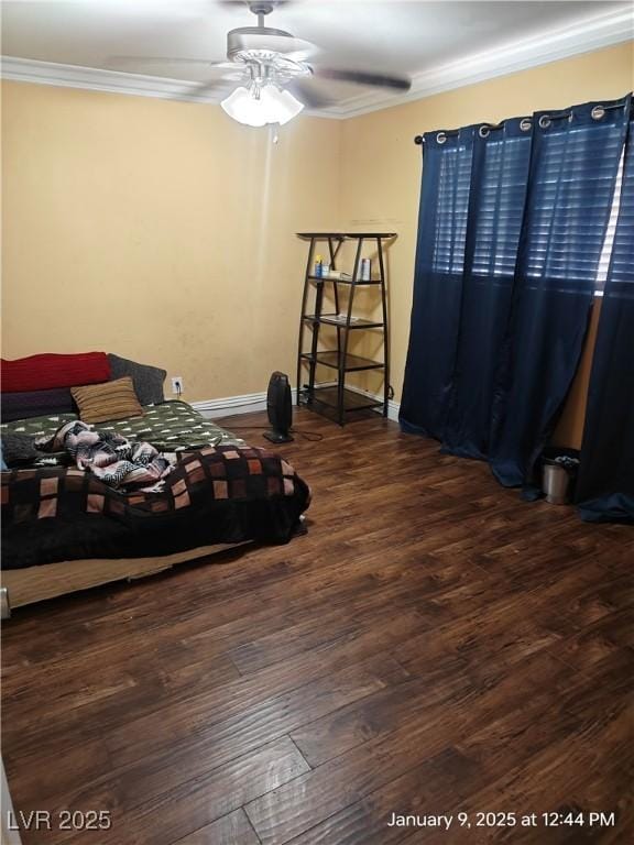 bedroom featuring ceiling fan, ornamental molding, and dark wood-type flooring