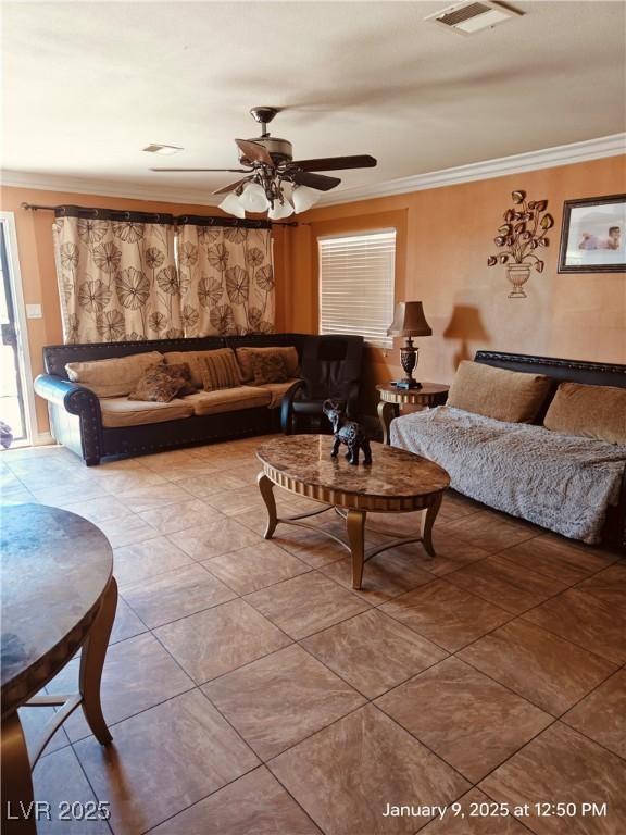 living room with crown molding and ceiling fan