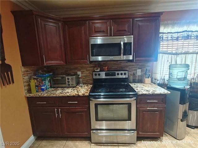 kitchen with light stone countertops, light tile patterned floors, stainless steel appliances, and tasteful backsplash