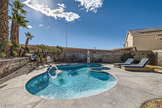 view of pool featuring pool water feature, an in ground hot tub, and a patio