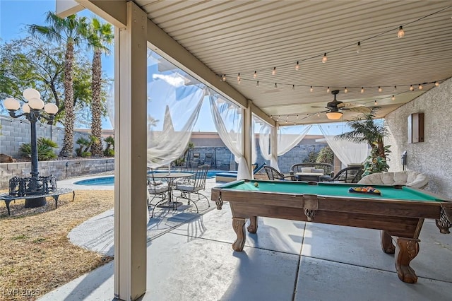 view of patio featuring ceiling fan, a fenced in pool, and a mountain view