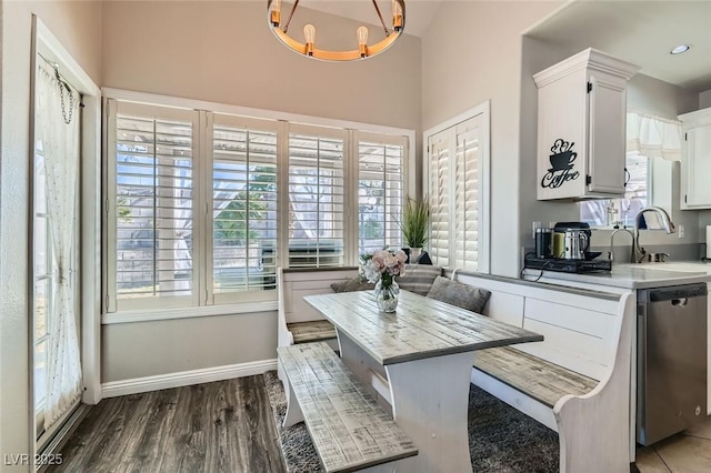 dining room with dark hardwood / wood-style floors, breakfast area, and sink