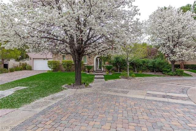 obstructed view of property with a garage