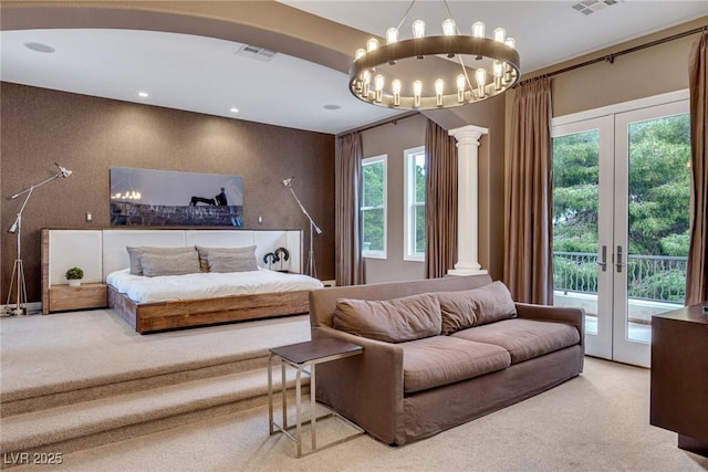 carpeted bedroom with ornate columns, french doors, an inviting chandelier, and access to exterior