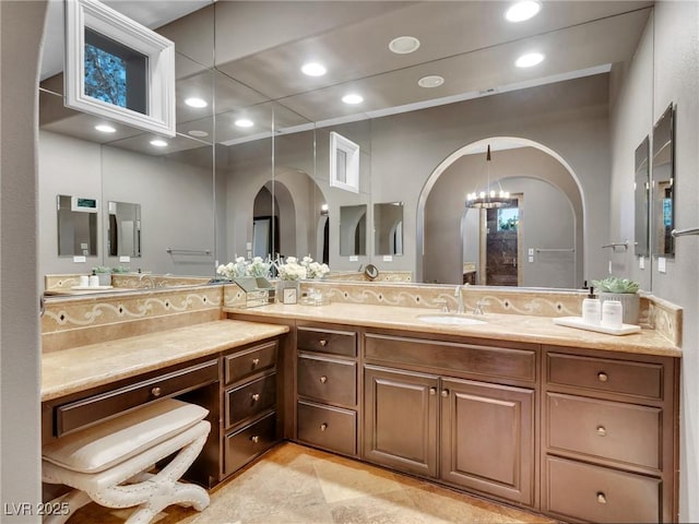 bathroom featuring vanity, tile patterned flooring, and a chandelier