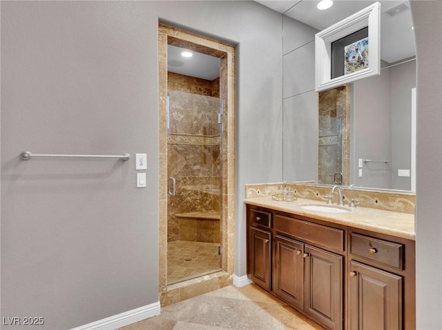 bathroom featuring tile patterned floors, walk in shower, and vanity